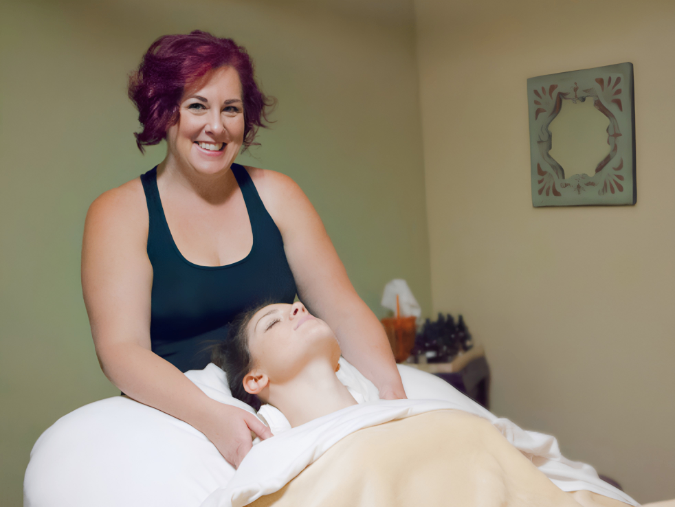 Lisa M. Clark, Licensed Massage Therapist, working with a client